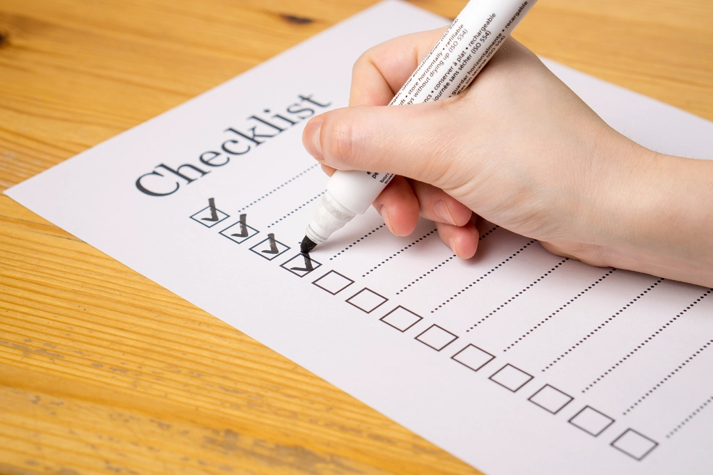 Hand writing a checklist, representing a website launch checklist