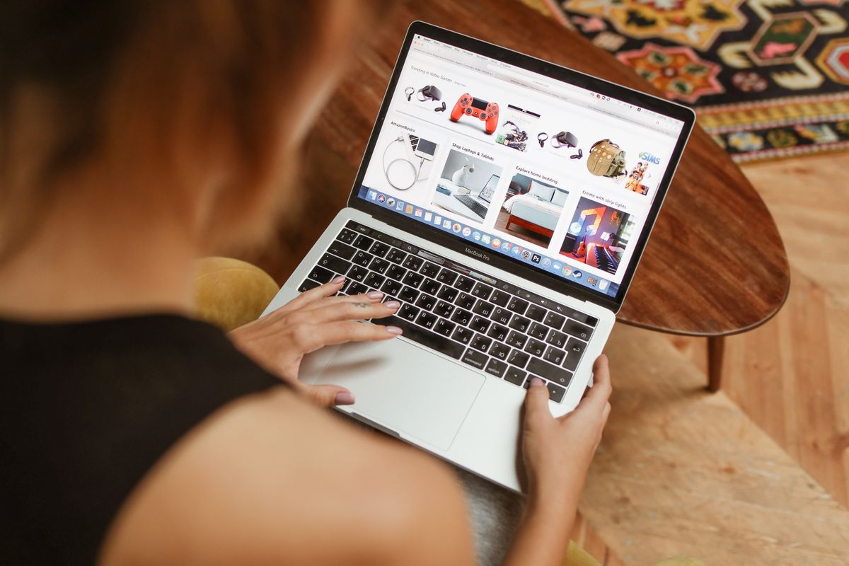 Person shopping online on a laptop, illustrating WooCommerce performance